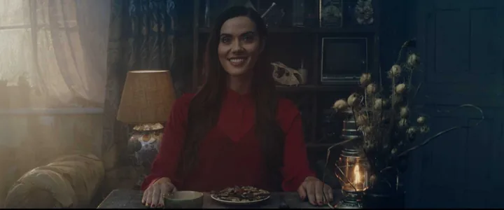 A woman at a table in Girlfriend Deluxe