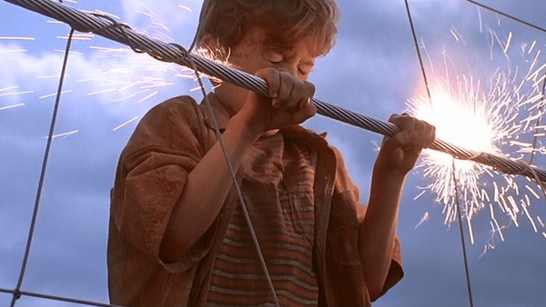 Jurassic Park film still of a boy gripping a sparking electric fence